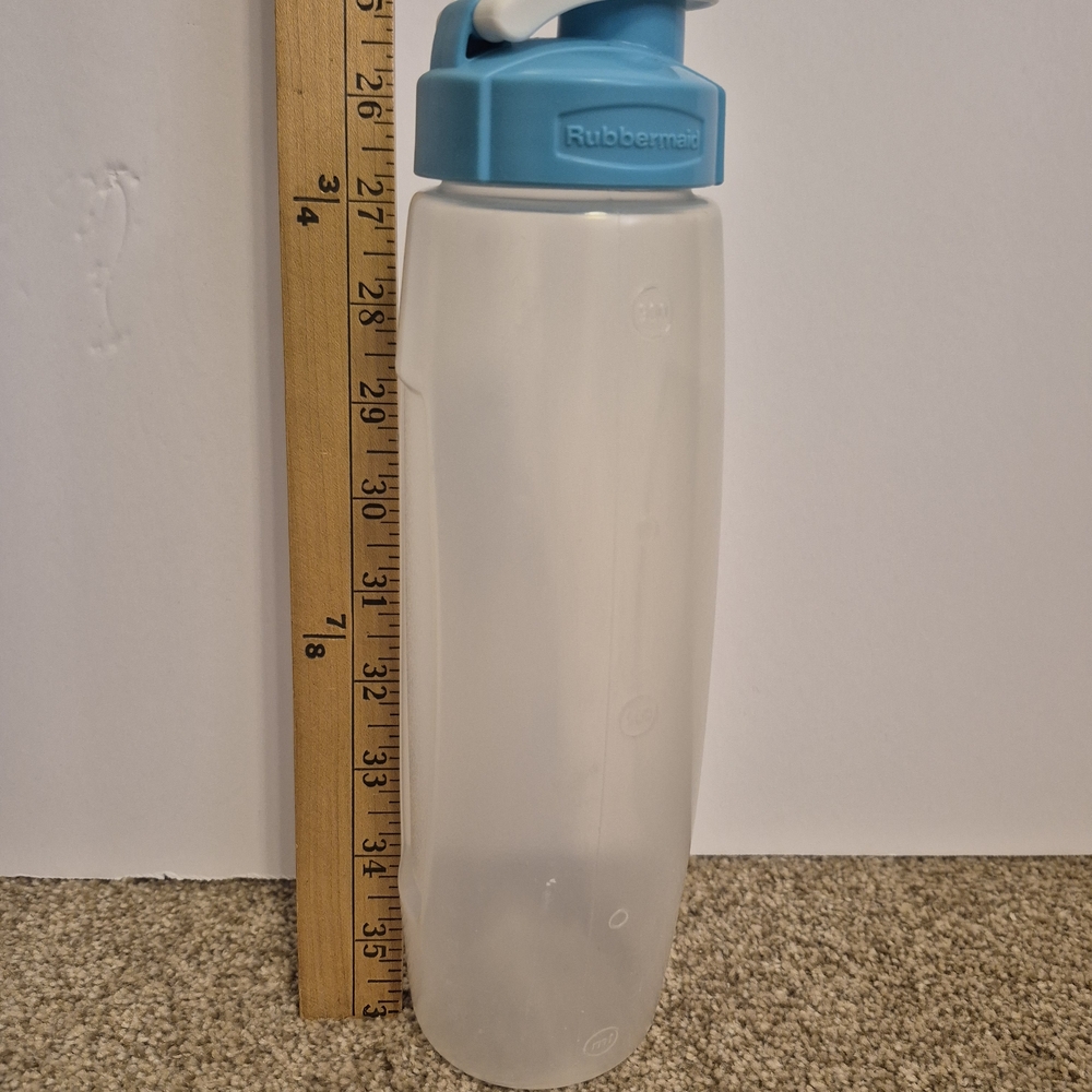 Clear plastic Rubbermaid water bottle with a blue Flip Top Blue lid 32oz